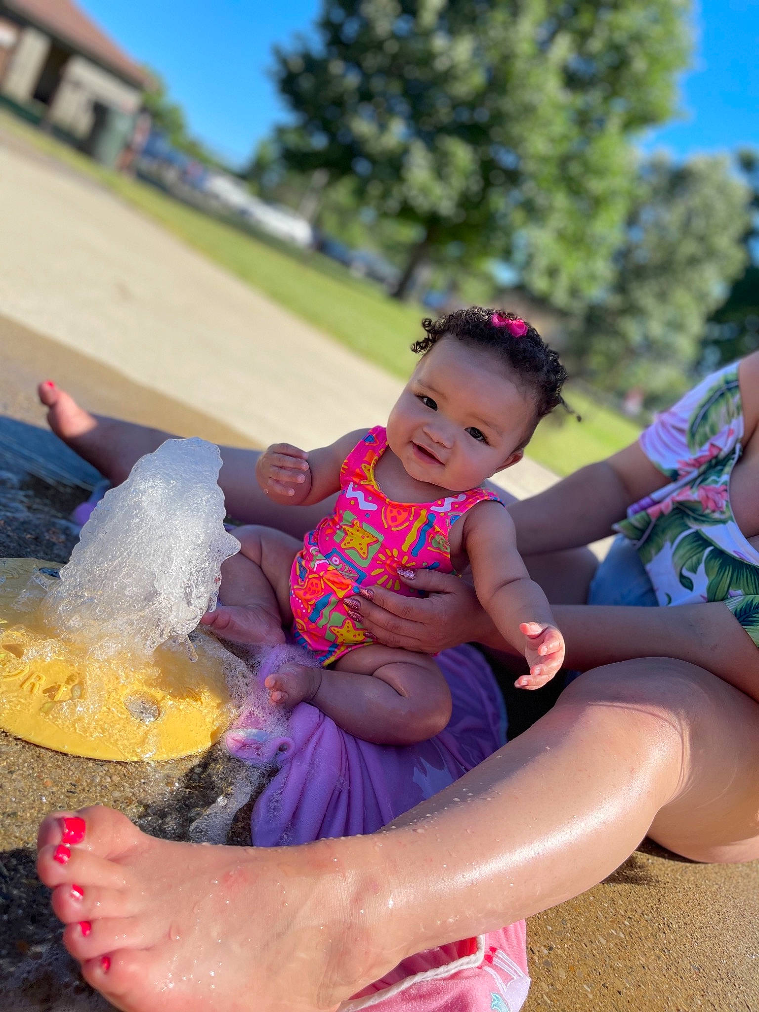 Taylynn is registered to the contest to win money with this photo: baby, baby_toddler_clothing, child, event, fun, grass, happy, human_leg, leisure, magenta, outdoor_recreation, people_in_nature, person, pink, plant, recreation, sandal, sitting, sky, toddler