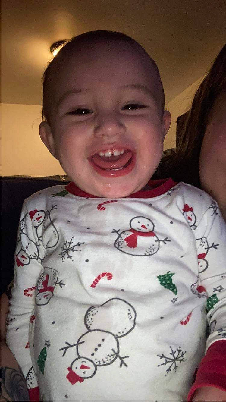 Mateo is registered to the contest to win money with this photo: baby_toddler_clothing, cheek, chin, comfort, facial_expression, finger, gesture, happy, jaw, joy, lip, mouth, neck, nose, organ, person, skin, sleeve, smile, t_shirt