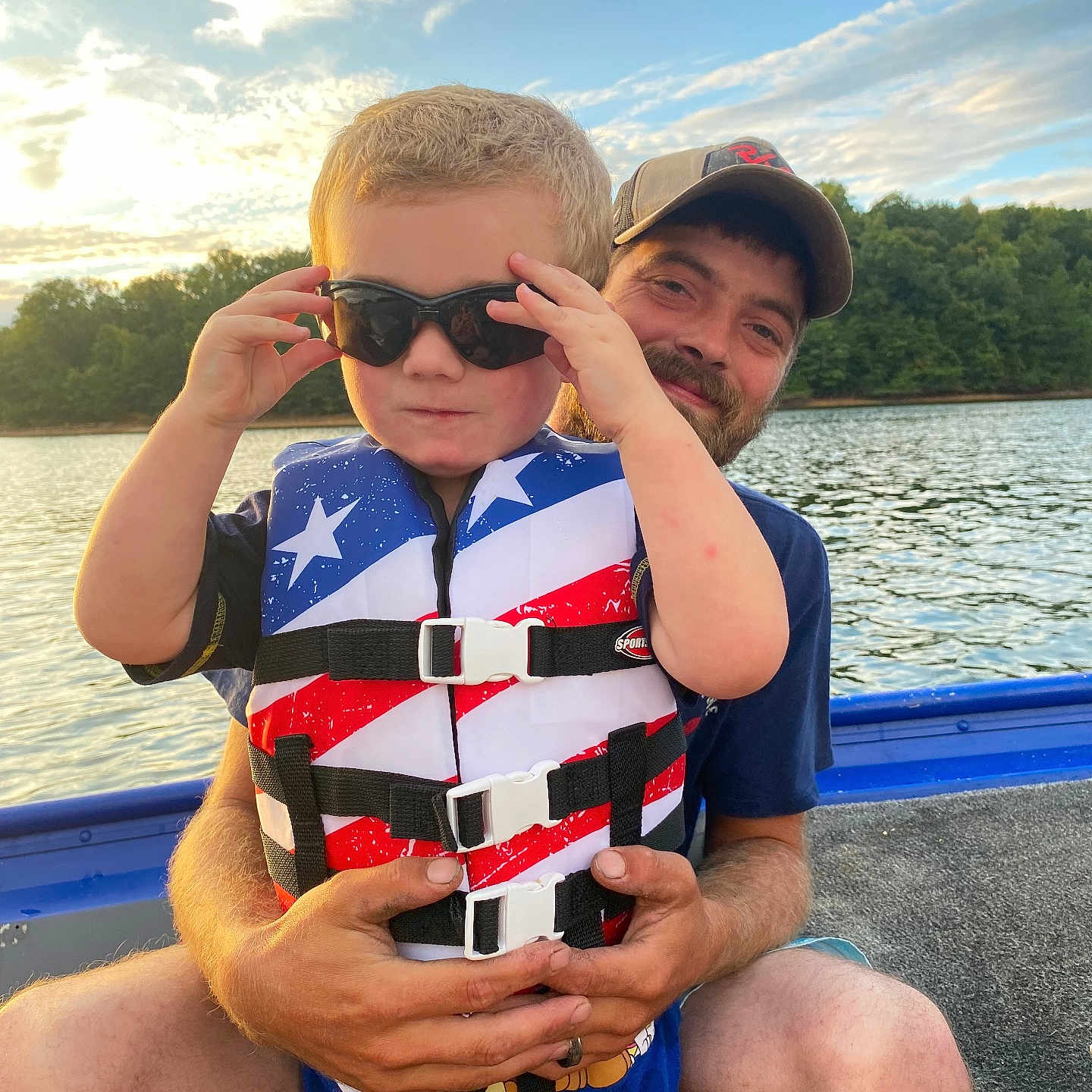 Dawson is registered to the contest to win money with this photo: accessories, adult, clothing, face, head, lake, lifejacket, male, man, nature, outdoors, person, photography, portrait, shorts, summer, sunglasses, swimwear, vest, water