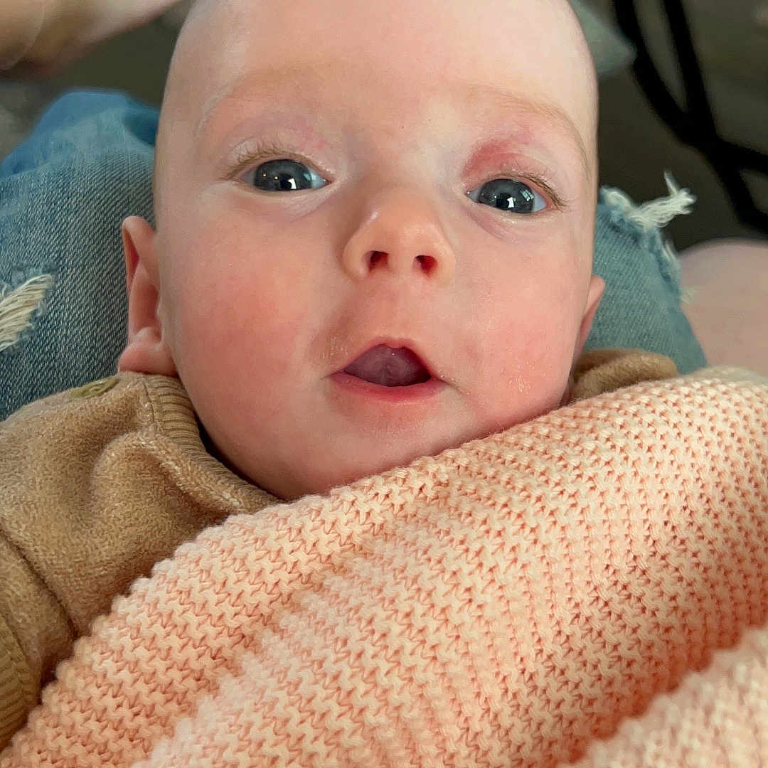 Maeve joined the competition — help win amazing prizes! baby, blanket, bodypart, clothing, couch, cushion, face, finger, furniture, hand, head, homedecor, linen, newborn, pants, person, photography, portrait, quilt, towel