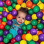 architecture, baby, ball, balloon, clothing, face, football, head, indoors, outdoors, person, photography, playarea, portrait, purple, soccer, soccerball, sphere, sport, t_shirt