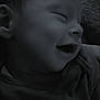 Kylo is registered to the contest to win money with this photo: baby, smiling, sleeping, face, hand, closeup, infant, peaceful, soft_lighting, portrait, child, cute, resting, dark_background, monochrome, newborn, tiny_hand, cozy, content, happy