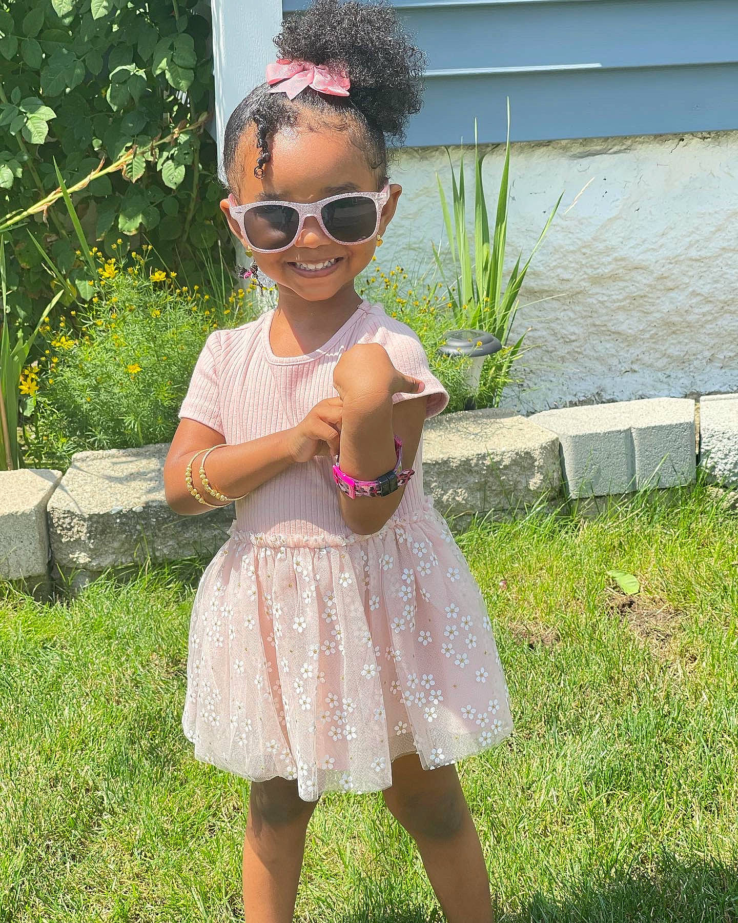 Solar is registered to the contest to win money with this photo: baby_toddler_clothing, clothing, day_dress, dress, eyewear, glasses, goggles, grass, hair, happy, joy, one_piece_garment, person, pink, plant, shoe, shoulder, sleeve, smile, sunglasses