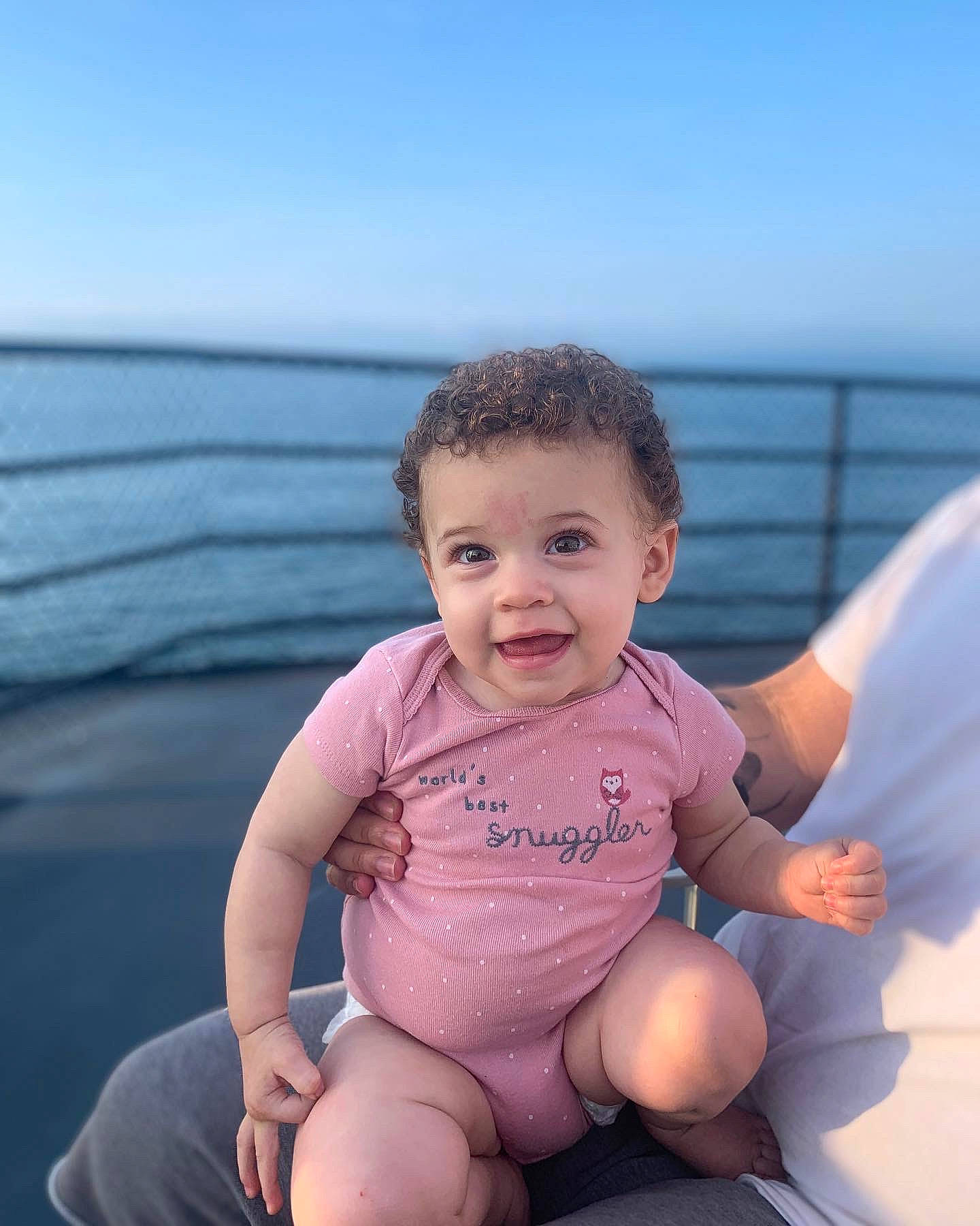 Laila is registered to the contest to win money with this photo: baby, baby_toddler_clothing, barefoot, eye, face, flash_photography, foot, fun, happy, head, human_body, leg, leisure, person, skin, sky, sleeve, smile, thigh, toddler