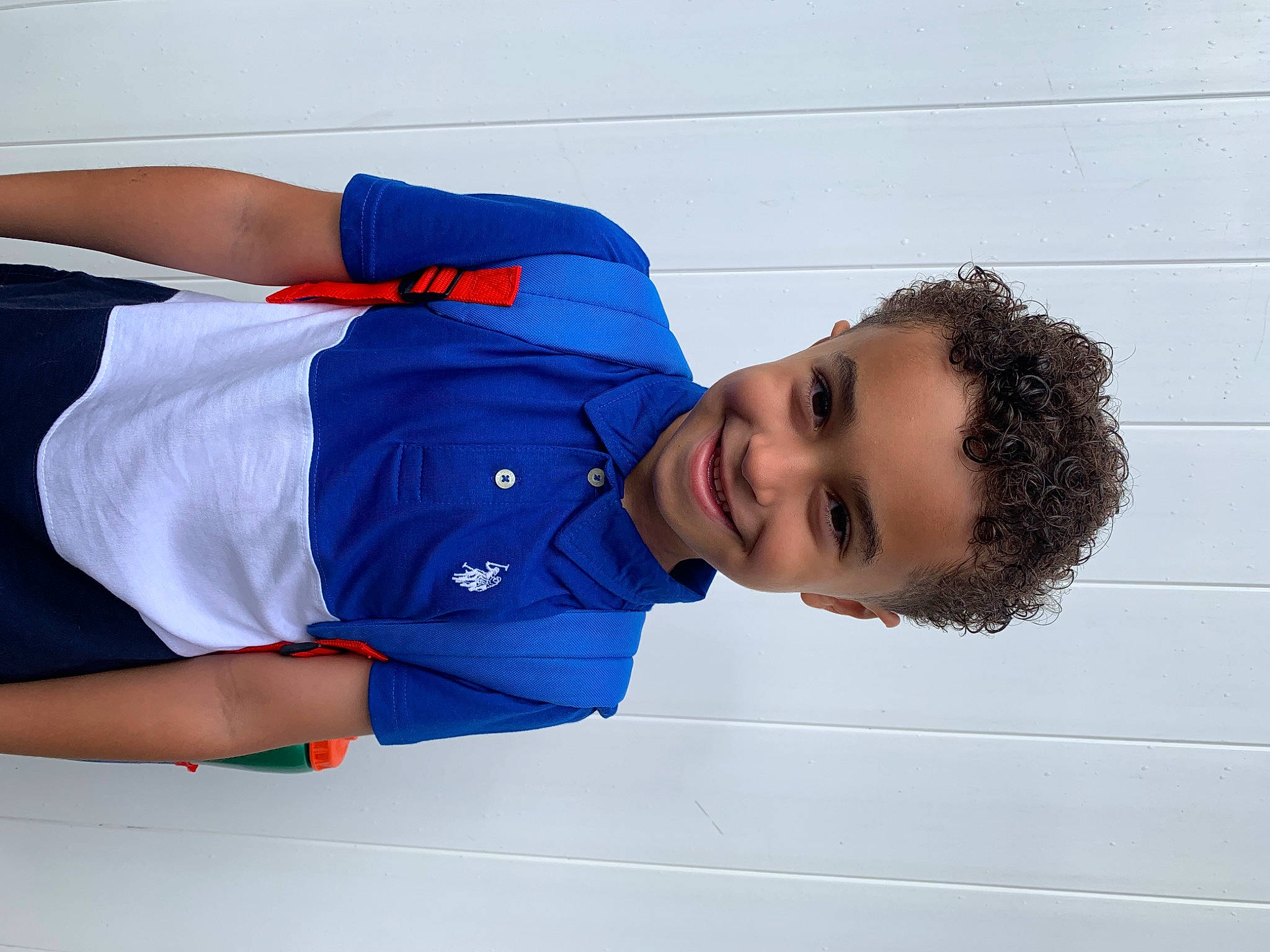 Levi is registered to the contest to win money with this photo: azure, blue, collar, comfort, elbow, electric_blue, gesture, happy, joy, person, portrait_photography, sleeve, smile, sportswear, t_shirt, wrist