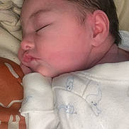 Riley is registered to the contest to win money with this photo: architecture, baby, bed, bedroom, blanket, building, clothing, cushion, face, furniture, glove, head, homedecor, hospital, newborn, person, photography, portrait, quilt, sleeping