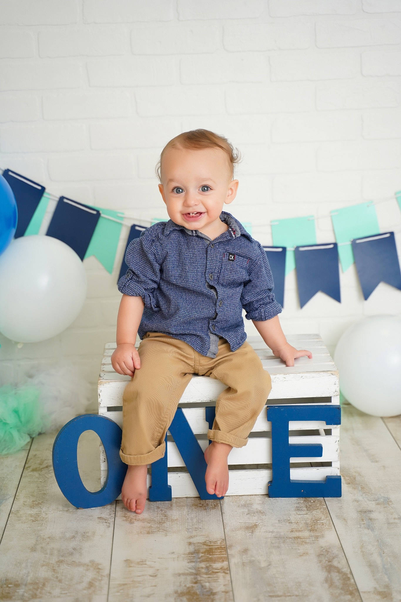 Dash is registered to the contest to win money with this photo: azure, baby_toddler_clothing, balloon, barefoot, blue, child, comfort, design, electric_blue, flooring, fun, happy, joy, knee, leisure, person, play, shorts, sitting, smile