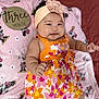 baby, infant, child, girl, headband, dress, floral_pattern, orange, pink, blanket, minnie_mouse, soft_texture, wooden_sign, three_months, milestone, cute, smiling, lying_down, indoors, portrait