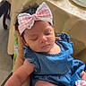 Leilani is registered to the contest to win money with this photo: baby, infant, sleeping, headband, bow, blue_dress, newborn, hand, arm, indoor, table, bowl, food, cup, chair, person, soft_lighting, peaceful, closeup, portrait