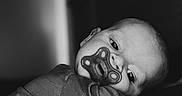 Weston joined the competition — help win amazing prizes! baby, black_and_white, blanket, child, closeup, cozy, cute, expression, eyes, face, fidget_spinner, head, indoors, infant, mouth, pacifier, portrait, resting, sleepwear, soft_light