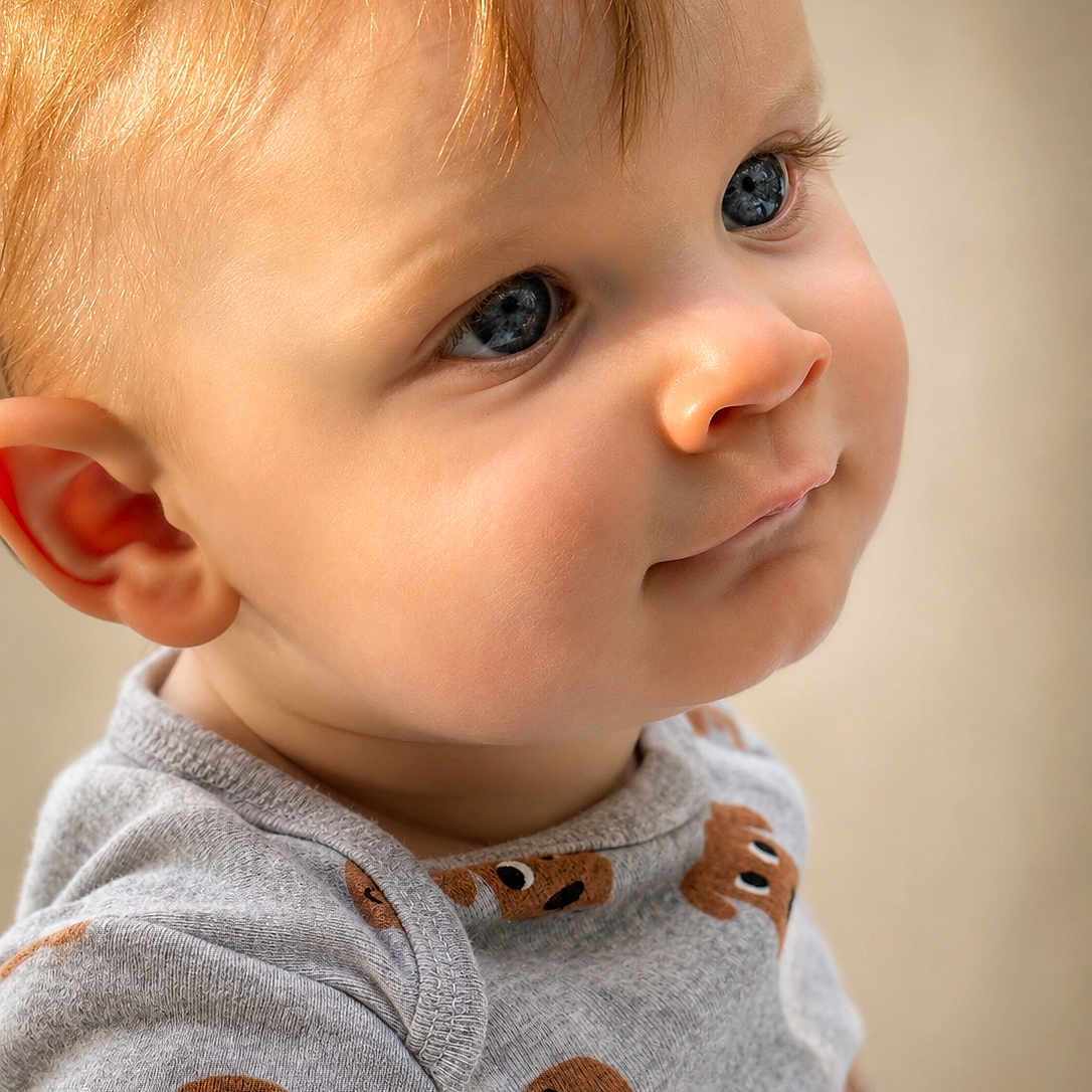 Weston is registered to the contest to win money with this photo: toddler, child, portrait, face, blue_eyes, light_hair, cute, expression, clothing, grey_shirt, cartoon_bears, close_up, indoor, baby, skin, young_child, looking_away, soft_light, casual_wear, adorable