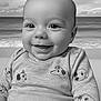 Ezio a rejoint le concours — aidez-le/la à gagner de superbes lots ! baby, smiling, infant, sweater, dog_pattern, portrait, black_and_white, ocean, beach, background, cute, child, happy, face, clothing, seaside, calm, young, sitting, closeup