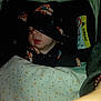 baby, sleeping, blanket, car_seat, hat, teddy_bear_pattern, face, infant, child, clothing, cozy, indoor, warning_label, airbag, comfort, peaceful, cute, resting, headwear, portrait