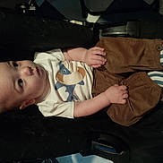 Ezio participe au concours pour gagner de l'argent avec cette photo : baby, child, infant, toddler, white_shirt, animal_print, brown_pants, striped_socks, sitting, curious, indoors, black_surface, cute, small_hands, portrait, young_child, clothing, footwear, expression, floor_tiles