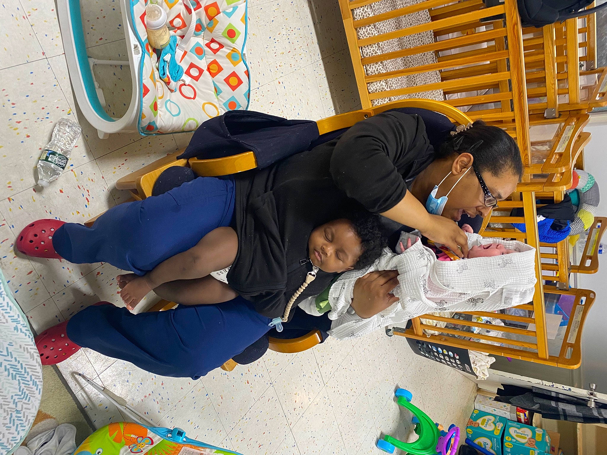 Adonis is registered to the contest to win money with this photo: art, bag, child, comfort, engineering, event, flooring, fun, human_leg, knee, lap, leisure, luggage_and_bags, person, room, shelf, sitting, t_shirt, thigh, visual_arts