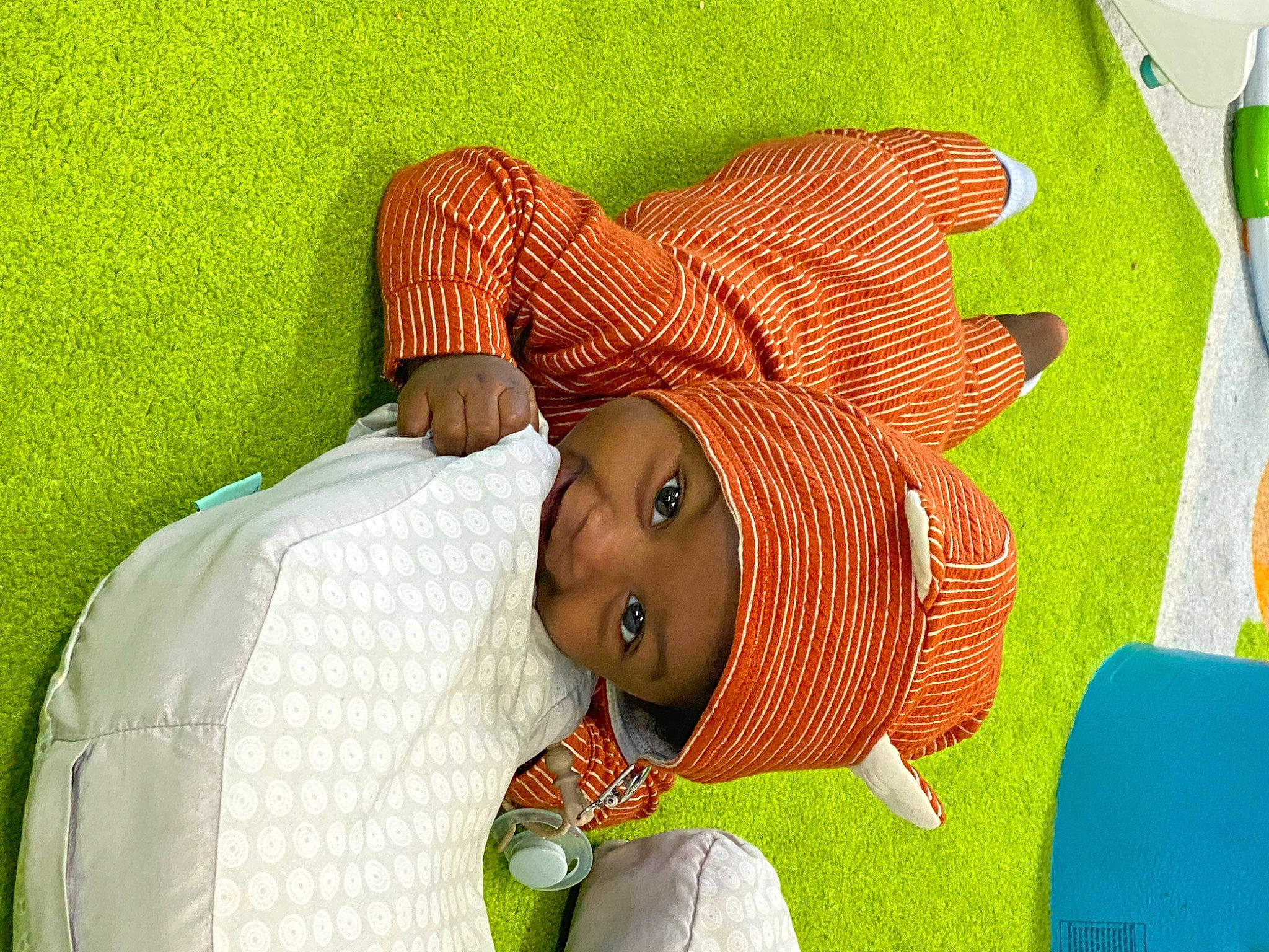 Adonis is registered to the contest to win money with this photo: baby, baby_products, baby_toddler_clothing, child, comfort, grass, happy, hat, headwear, linens, pattern, person, room, sleeve, textile, toddler