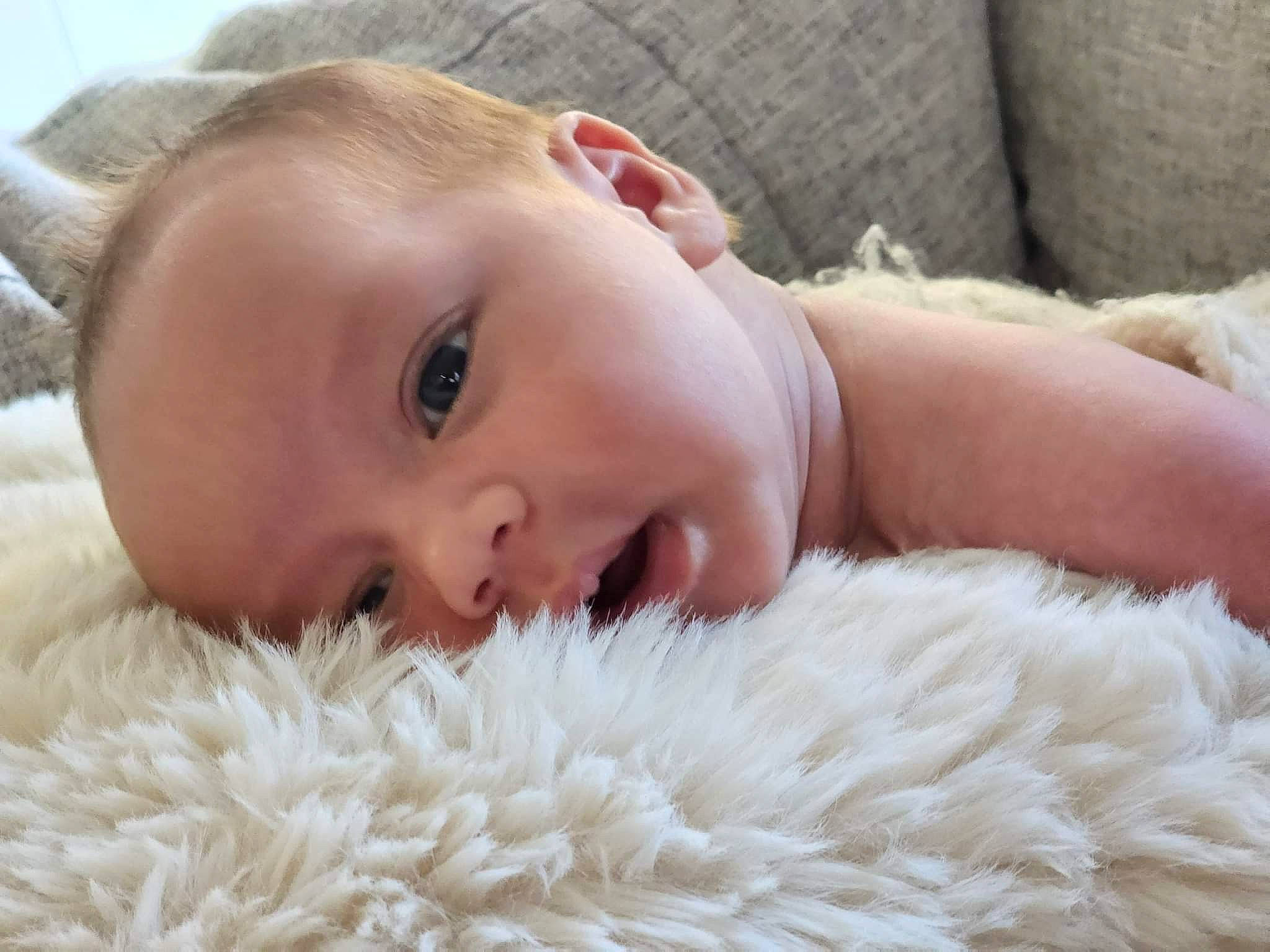 Jaden is registered to the contest to win money with this photo: baby, baby_toddler_clothing, cheek, chin, comfort, eye, eyebrow, eyelash, face, fur_clothing, happy, headgear, iris, linens, lip, mammal, nose, person, skin, textile