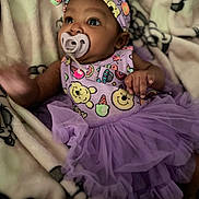 Nevaeh joined the competition — help win amazing prizes! baby, child, pacifier, headband, purple_dress, tutu, blanket, infant, cute, smiling, portrait, clothing, indoors, baby_girl, soft_toys, patterned_blanket, small_hands, curious_look, lying_down, close_up