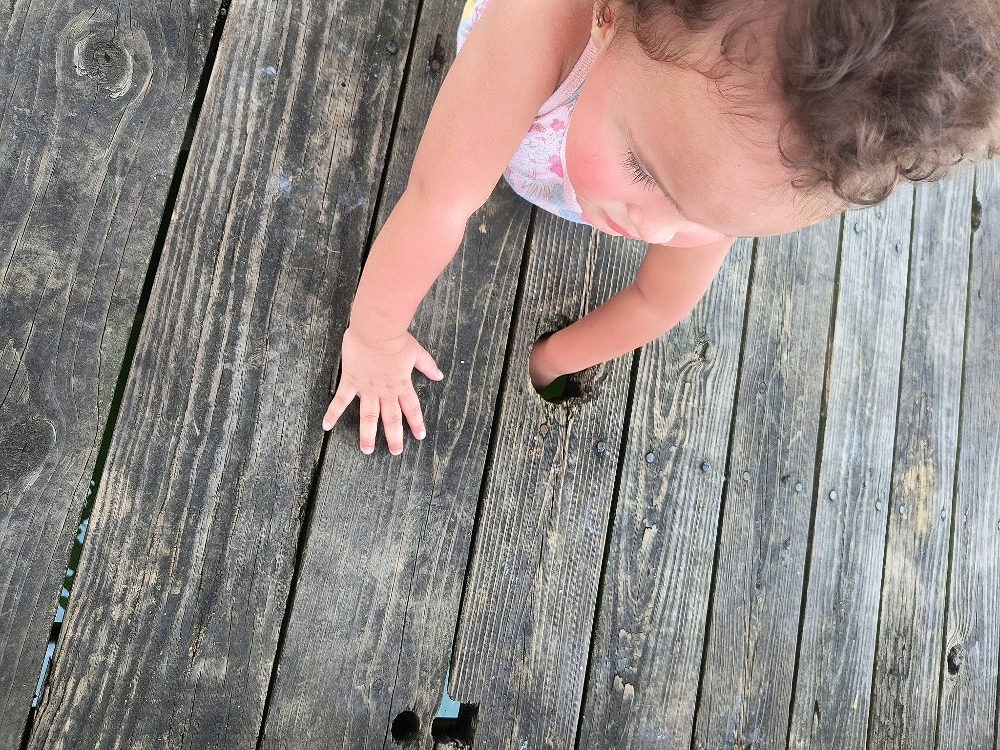Kahlani is registered to the contest to win money with this photo: eye, finger, floor, flooring, foot, gesture, grass, happy, hardwood, human_leg, nail, people_in_nature, person, plant, skin, thigh, thumb, toddler, tree, wood