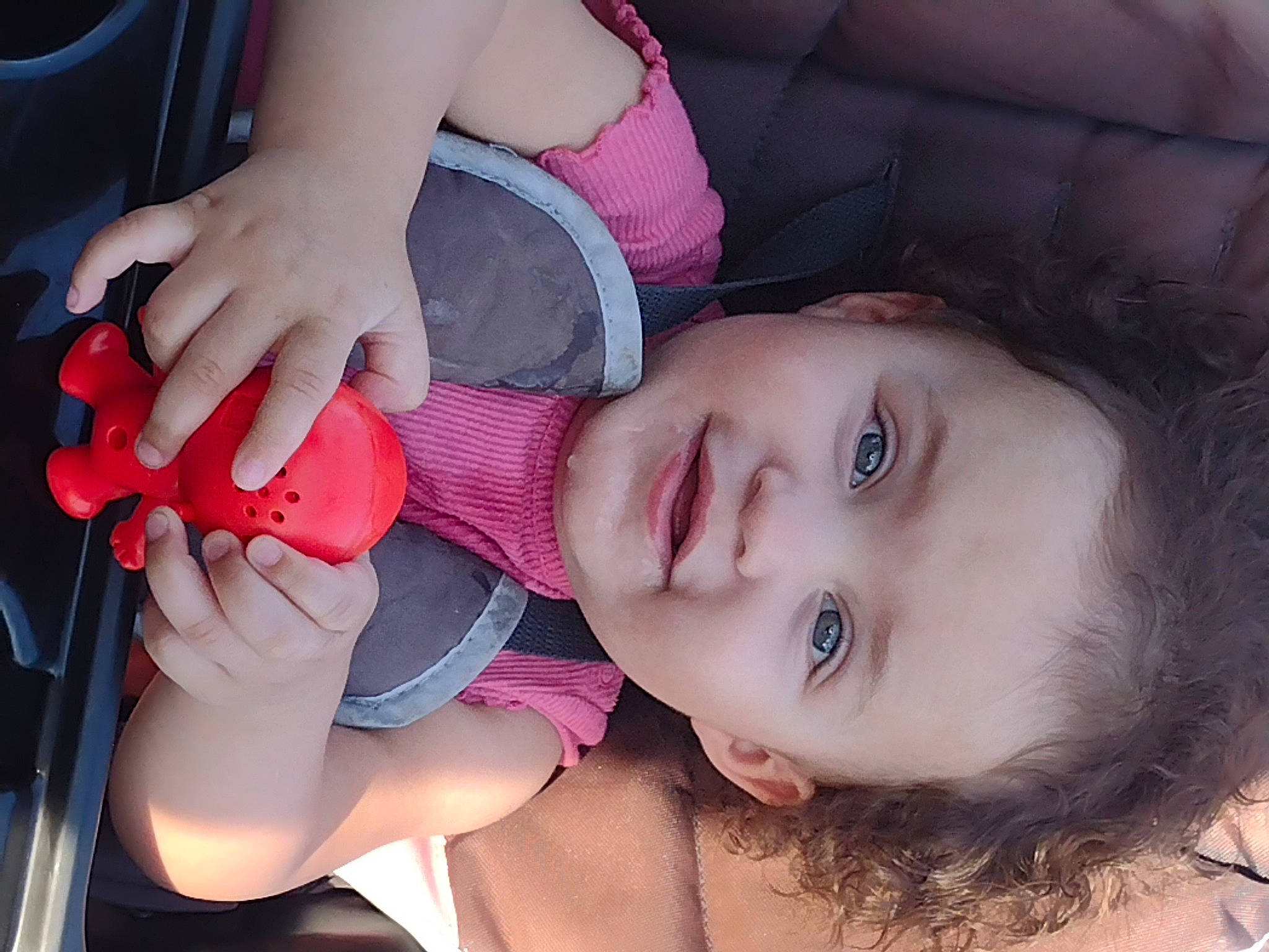 Kahlani is registered to the contest to win money with this photo: cheek, eyebrow, eyelash, face, finger, flash_photography, gesture, hand, happy, iris, lip, mouth, neck, nose, person, pink, plant, skin, smile, toddler