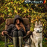 woman, dog, husky, chair, outdoor, grass, foliage, greenery, autumn, jacket, boots, pet, animal, nature, relaxation, leisure, portrait, seated, text_overlay, advertisement
