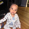 Jayce is registered to the contest to win money with this photo: baby, child, infant, floor, wooden_floor, indoors, clothing, onesie, socks, face, person, seated, car_seat, hand, curious, eyes, cute, portrait, room, home