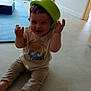 toddler, child, smiling, green_bowl, hat, sitting, floor, indoor, casual_clothing, playful, happy, baby, crawling_mat, barefoot, cute, fun, light, home, young, person