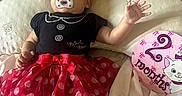 Nazaria joined the competition — help win amazing prizes! baby, infant, pacifier, headband, red_bow, polka_dot_skirt, black_top, bed, blanket, pillow, milestone_sign, 2_months, cartoon_cat, clothing, person, cute, lying_down, soft_toys, indoor, happy