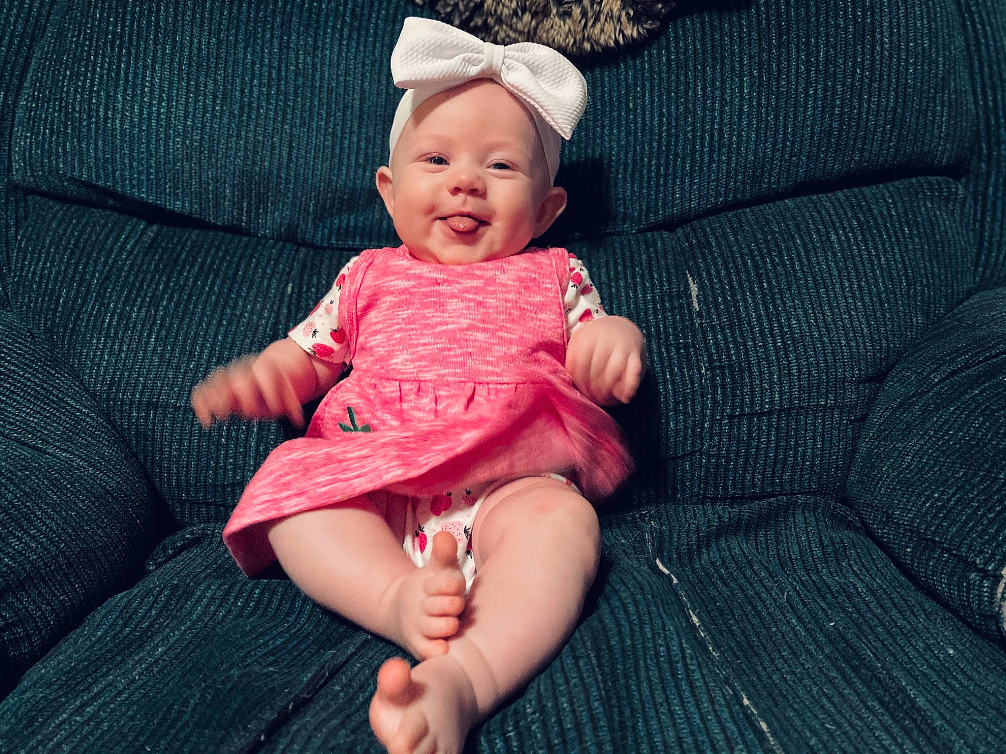 Aubriella is registered to the contest to win money with this photo: baby, baby_toddler_clothing, child, comfort, day_dress, dress, finger, foot, happy, hat, headgear, human_leg, pattern, person, pink, skin, sleeve, smile, textile, thigh