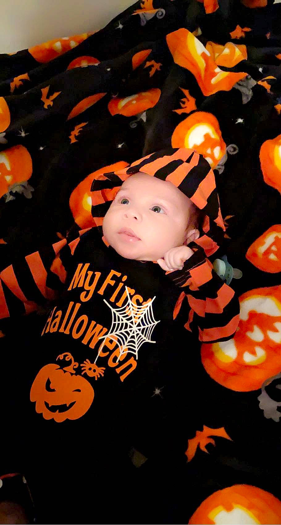 Jonahz is registered to the contest to win money with this photo: art, baby, baby_toddler_clothing, black, carmine, child, event, fictional_character, font, graphics, happy, headwear, holiday, logo, orange, person, t_shirt, toddler, toy, tree