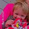 Rodger is registered to the contest to win money with this photo: toddler, child, blanket, colorful, fuzzy, smiling, happy, cute, person, adult, holding, portrait, indoor, wooden_panel, clothing, face, hand, hair, cozy, warm