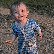 Rodger joined the competition — help win amazing prizes! toddler, child, smile, outdoor, sand, mobile_home, grass, striped_clothing, lion_patch, blue_socks, happy, portrait, standing, daylight, nature, grass_patch, dirt, cute, young_child, casual_clothing