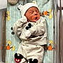Adriel is registered to the contest to win money with this photo: newborn, baby, sleeping, pacifier, mickey_mouse, pajamas, hat, mittens, booties, bassinet, hospital, plush_blanket, footprints, wooden_plaque, infant, clothing, cute, resting, baby_bed, soft