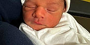 Adriel is registered to the contest to win money with this photo: newborn, baby, sleeping, white_hat, blanket, infant, cute, peaceful, face, headwear, resting, portrait, soft, cozy, indoors, human, child, wrapped, closeup, adorable