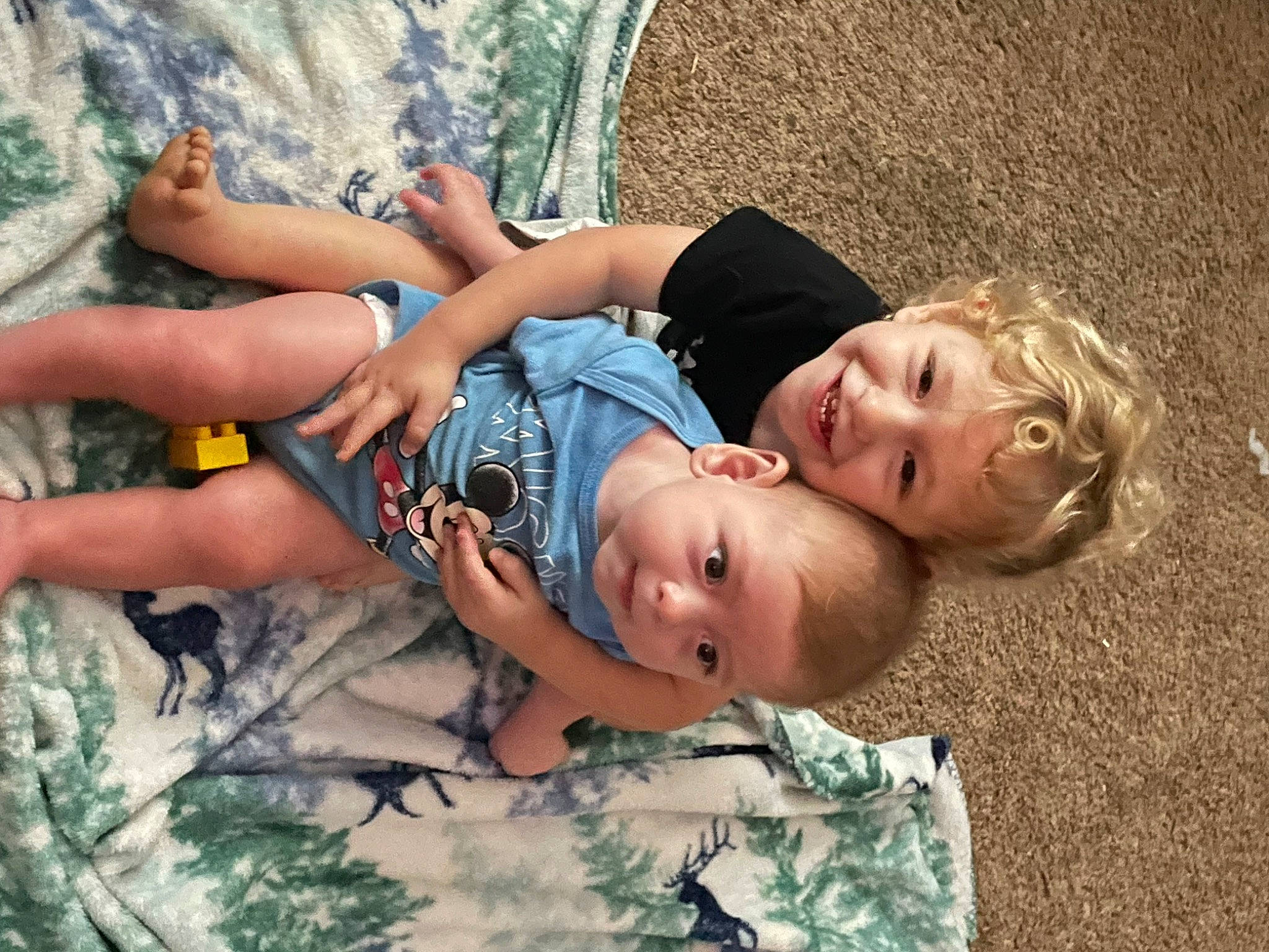 Brandon is registered to the contest to win money with this photo: camouflage, child, cool, fun, grass, happy, human_leg, joy, leisure, military_camouflage, military_uniform, pattern, person, plant, recreation, shorts, sitting, smile, t_shirt, thigh