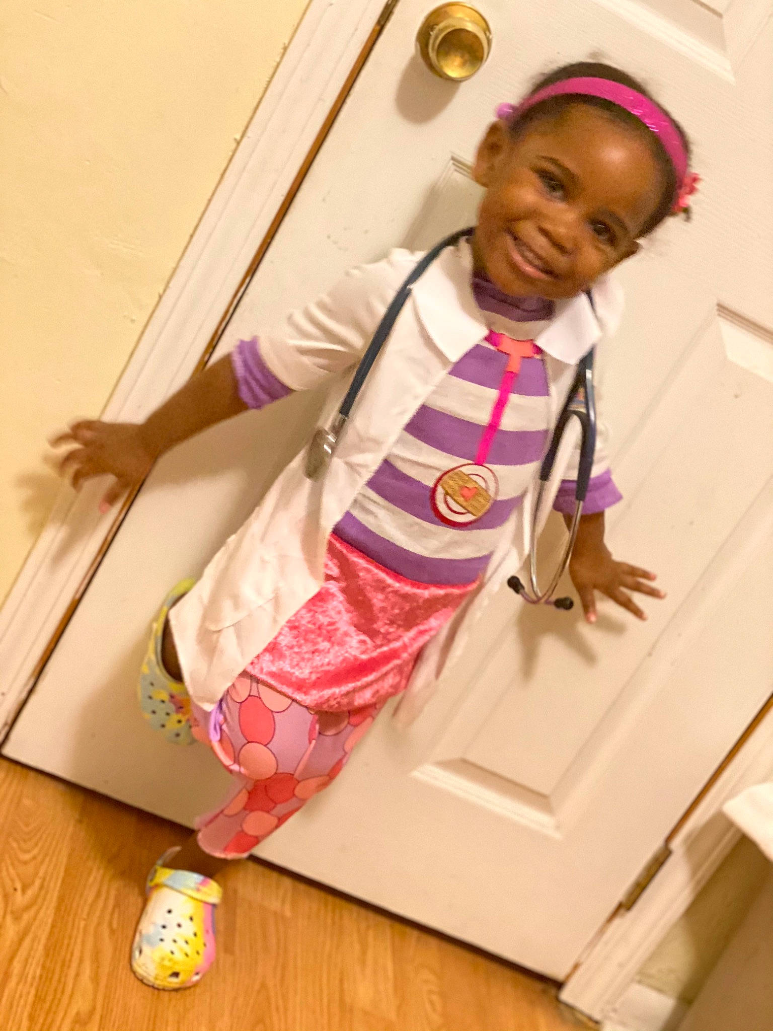 Kailyn is registered to the contest to win money with this photo: baby_toddler_clothing, ball, child, floor, flooring, hearing, joy, laminate_flooring, laugh, magenta, nightwear, pajamas, person, pink, sock, toddler, toy, wood_flooring
