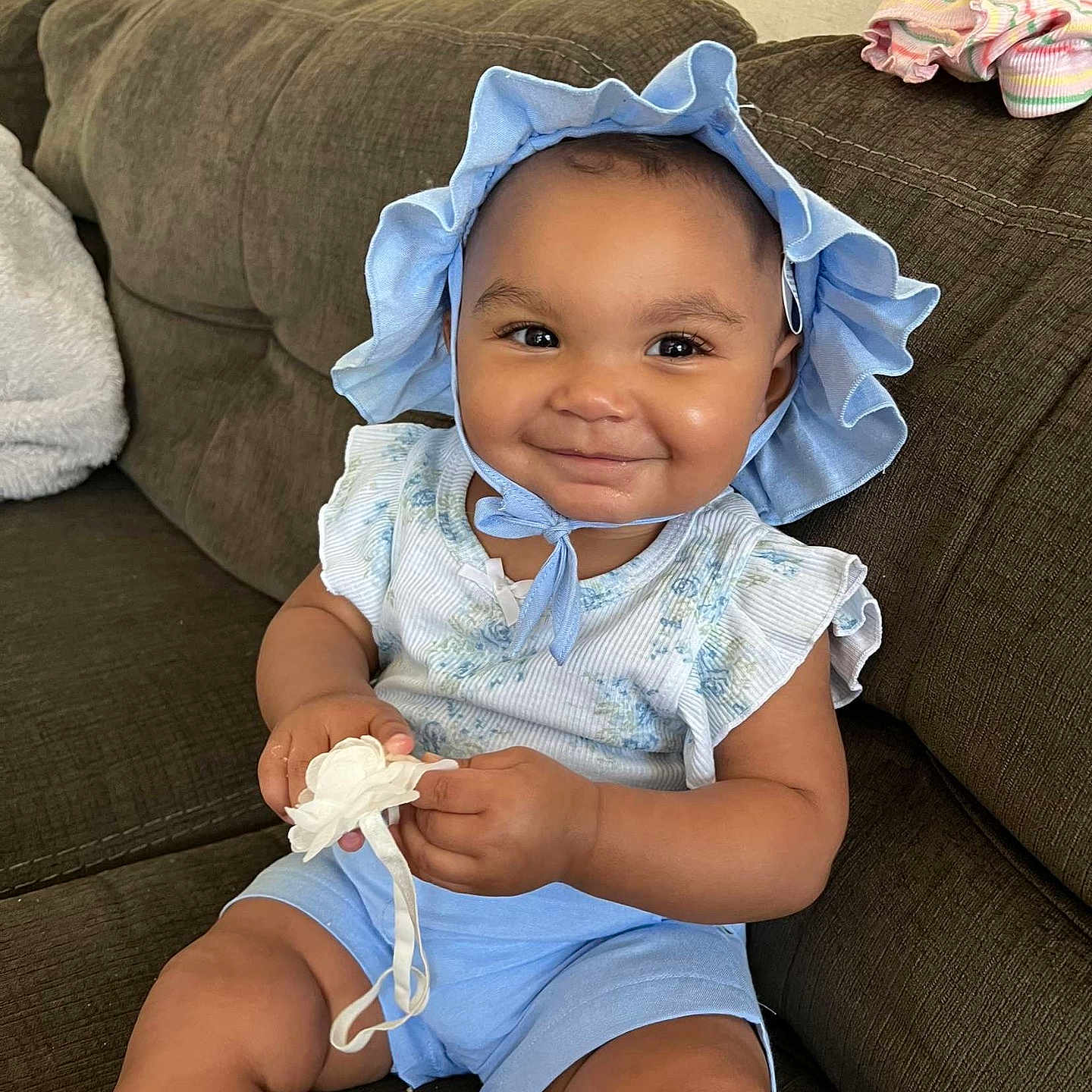 Kari joined the competition — help win amazing prizes! baby, babylaughing, bonnet, cap, clothing, couch, cushion, face, furniture, happy, hat, head, homedecor, person, photography, portrait, shorts, sitting, sleeve, smile