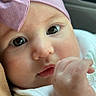 Brianna joined the competition — help win amazing prizes! baby, infant, face, headband, pink, bow, hand, thumb, clothing, white, close_up, portrait, cute, child, skin, eyes, expression, indoors, soft_light, person