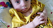 Kinzlee is registered to the contest to win money with this photo: baby, infant, yellow_shirt, blanket, duck_pattern, face, hands, lying_down, medical_wires, pacifier, curious, wide_eyes, cute, child, indoors, person, closeup, skin, expression, soft_lighting
