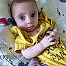 baby, infant, yellow_shirt, blanket, duck_pattern, face, hands, lying_down, medical_wires, pacifier, curious, wide_eyes, cute, child, indoors, person, closeup, skin, expression, soft_lighting
