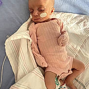 Kinzlee joined the competition — help win amazing prizes! infant, baby, sleeping, pink_onesie, hospital_bed, blanket, medical_patch, sock, child, person, resting, cute, small, newborn, healthcare, pediatric, peaceful, indoors, toddler, lying_down
