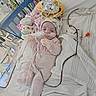 Kinzlee is registered to the contest to win money with this photo: baby, hospital, medical_equipment, nasal_tube, blanket, pajamas, hat, bed, wires, monitoring_device, infant, person, healthcare, cute, pink, cozy, child, lying_down, indoors, medical_care