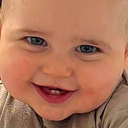 Damon is registered to the contest to win money with this photo: baby, smiling, face, blue_eyes, teeth, shirt, winnie_the_pooh, cartoon, child, infant, cute, portrait, closeup, skin, head, arm, clothing, happy, person, young