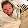 baby, candid, child, cozy, curious, cute, face, golden_buttons, holding, indoor, newborn, person, portrait, soft_texture, striped, sweater, towel, warmth, wide_eyes, wrapped