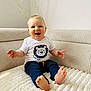 baby, child, smiling, sitting, indoors, couch, clothing, tshirt, pants, barefoot, face, happy, furniture, cozy, decor, branch, light, portrait, cute, infant