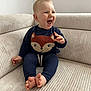 Maëlo a rejoint le concours — aidez-le/la à gagner de superbes lots ! baby, child, laughing, smiling, sitting, couch, indoor, clothing, foot, barefoot, cute, happy, infant, person, face, expression, apparel, home, cozy, comfort