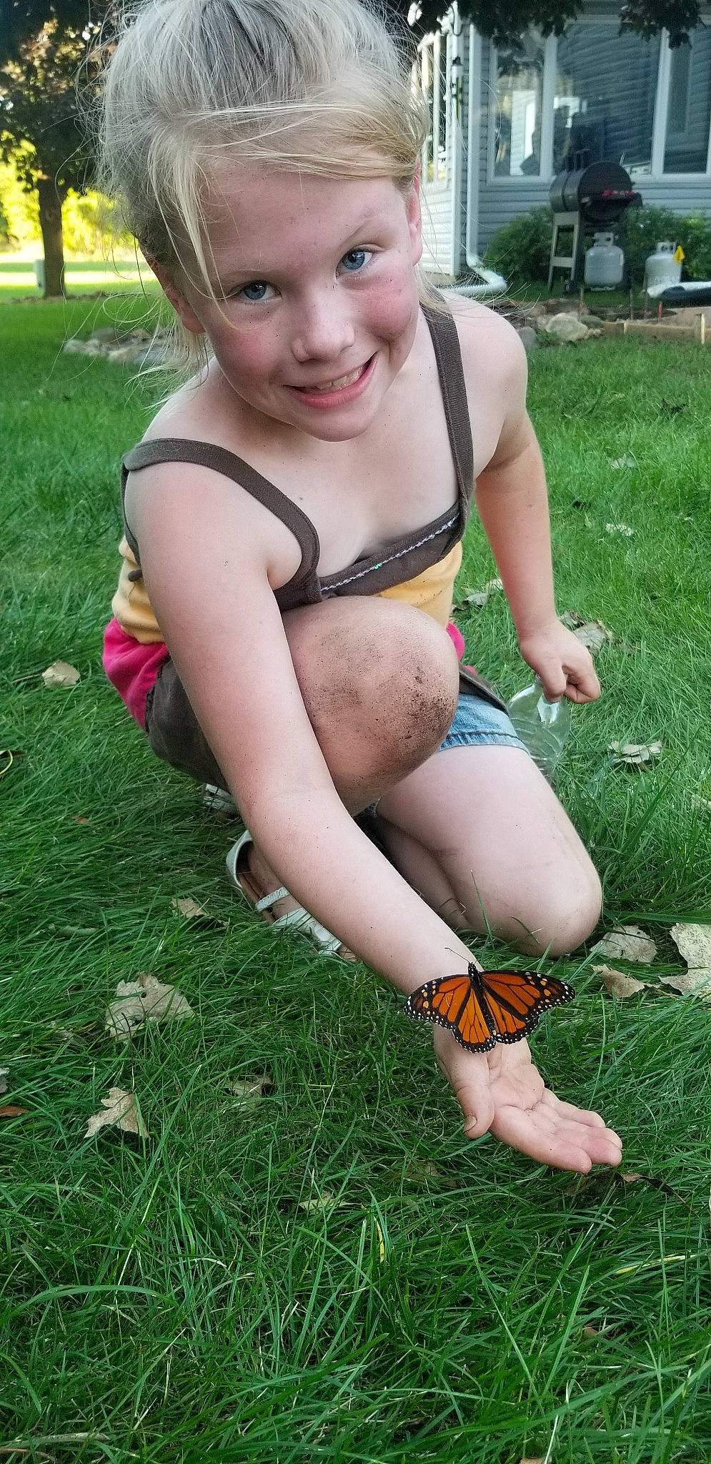 Lily is registered to the contest to win money with this photo: child, fawn, fun, grass, grass_family, joy, lawn, leg, person, plant, play, sitting, smile, summer, thigh