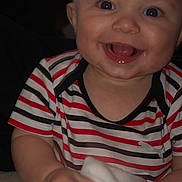 Emerson joined the competition — help win amazing prizes! baby, smiling, striped_shirt, cloth, happy, child, infant, cute, portrait, sitting, indoors, face, expression, hand, skin, head, young, person, toddler, clothing