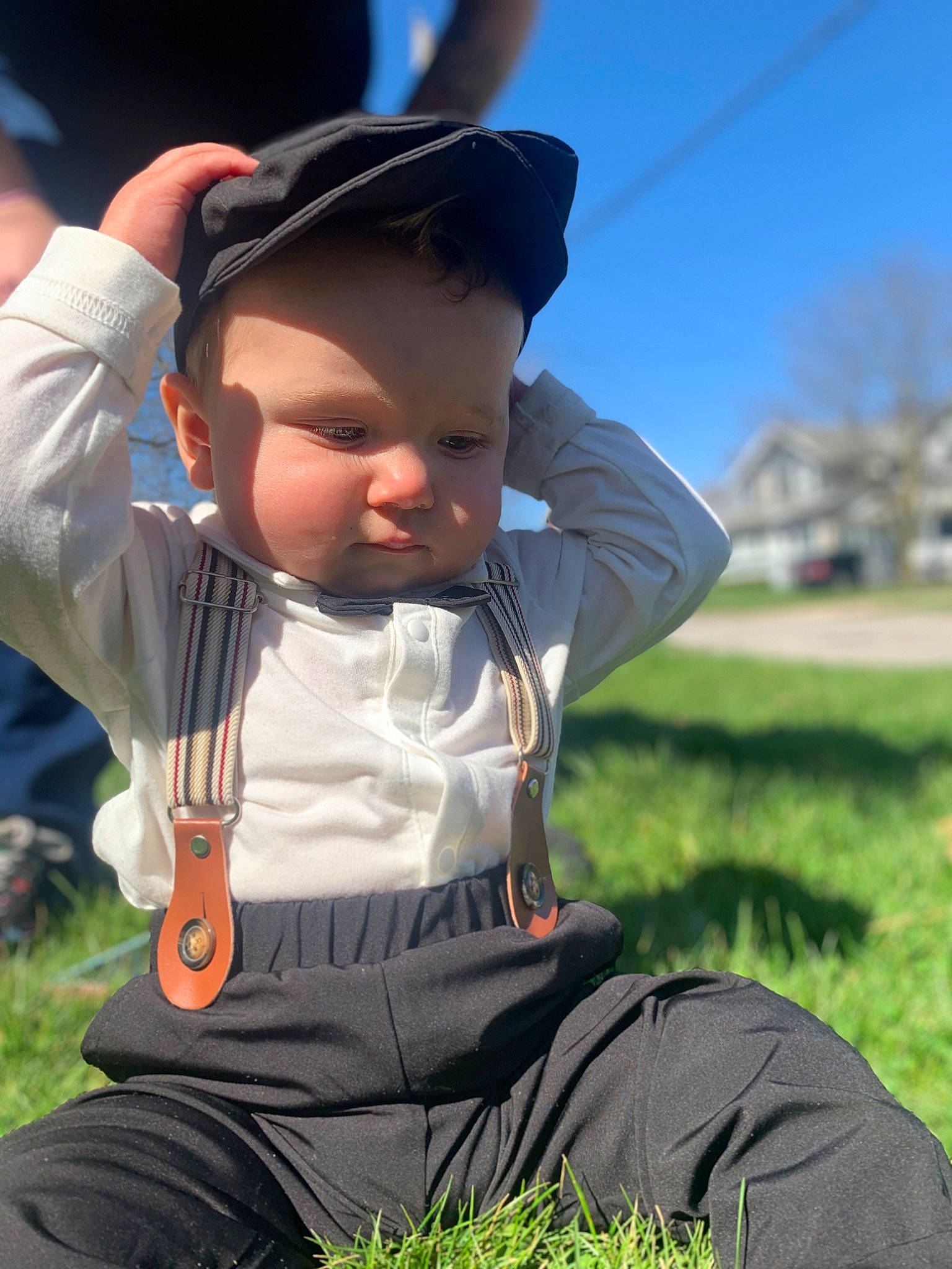 Alex is registered to the contest to win money with this photo: baby, baby_products, child, fun, gesture, grass, grassland, happy, headwear, lawn, leisure, meadow, people_in_nature, person, personal_protective_equipment, plant, recreation, sitting, sky, toddler