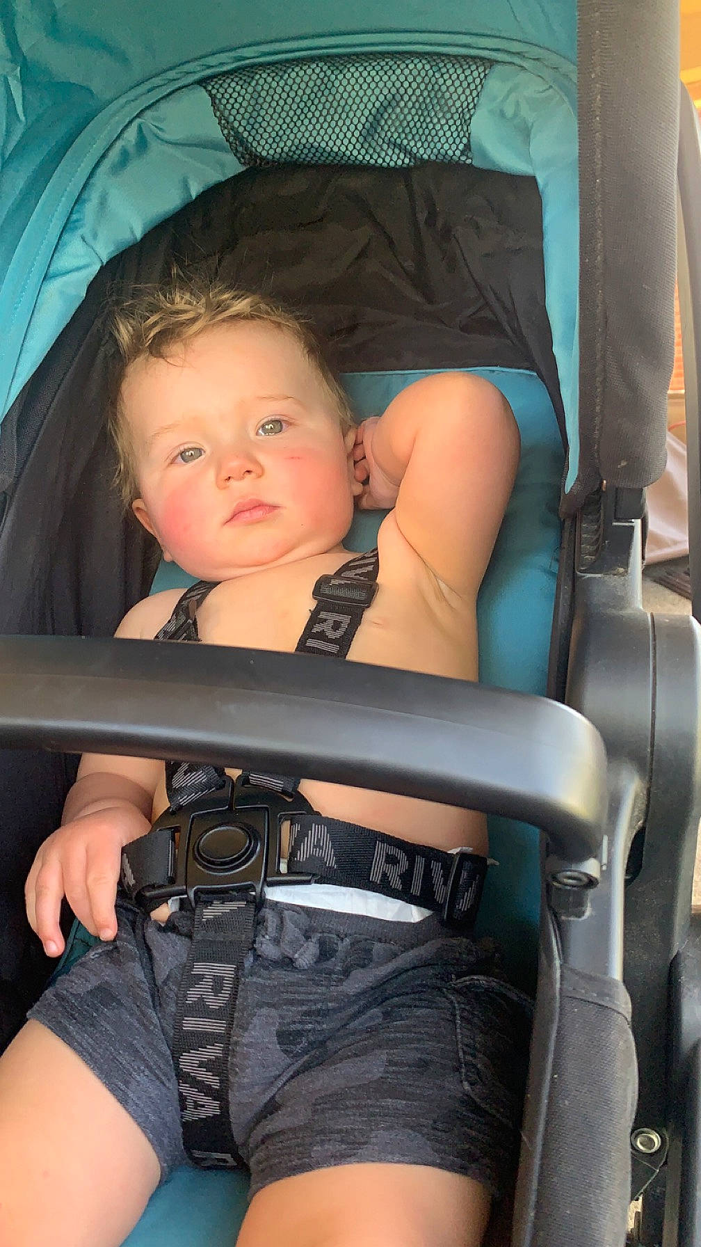 Alex is registered to the contest to win money with this photo: arm, auto_part, baby_carriage, baby_products, black_hair, blond, car_seat, chair, child, comfort, cool, eye, finger, flash_photography, hand, head_restraint, iris, joint, leg, person